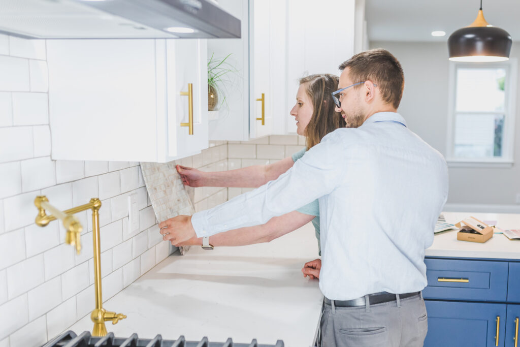 A couple picking a design for the kitchen backsplash