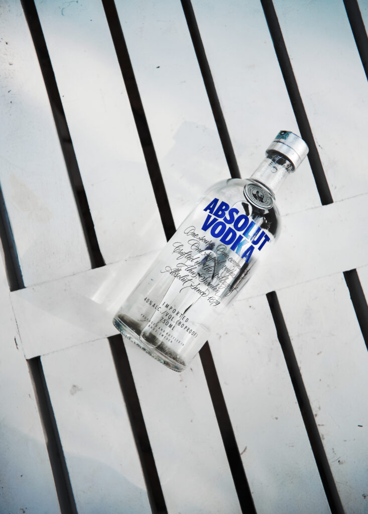 Absolut vodka on white wooden plank