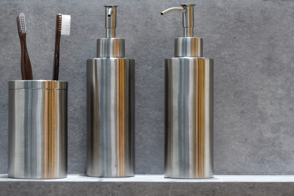 modern stainless steel soap dispenser and toothbrush holder