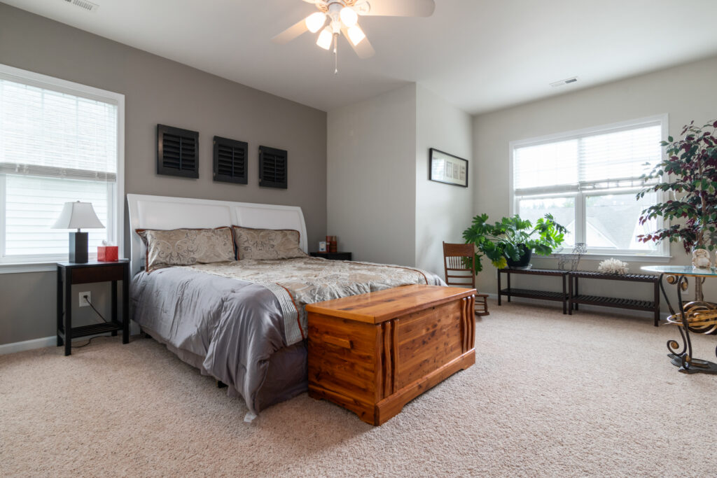 Wooden chest beside a bed in a bedroom