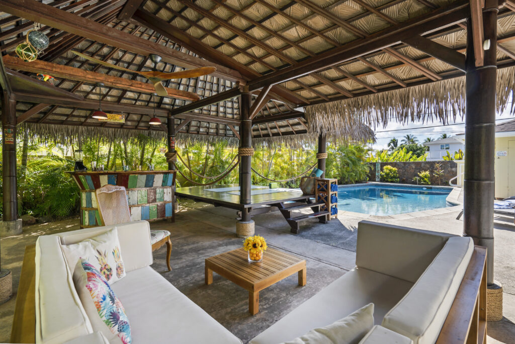 A cozy cabana close to a swimming pool