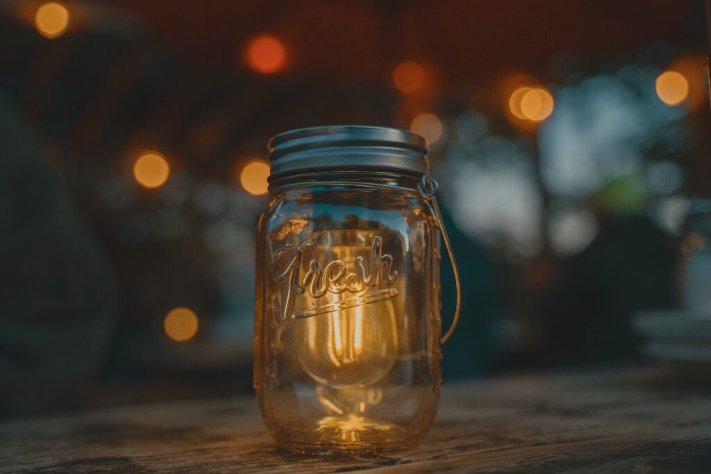 a mason jar with a light bulb inside of it
