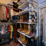 Assorted clothes and boots inside a closet room