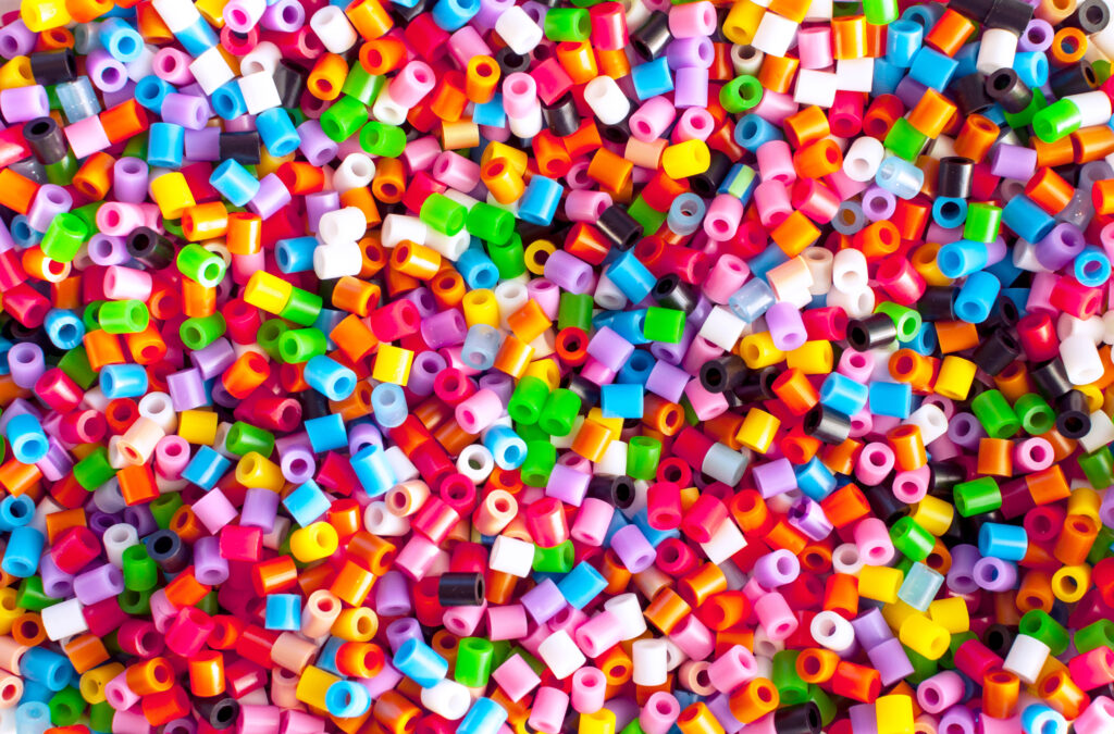 Bright colorful plastic perler beads. Abstract background