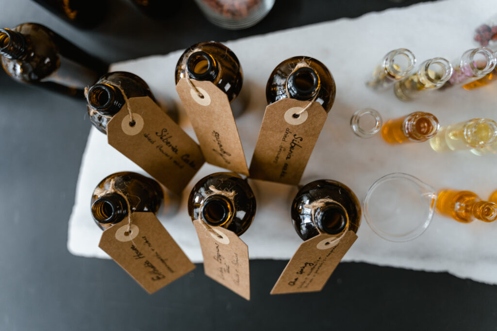 Brown bottles with tags on a white surface