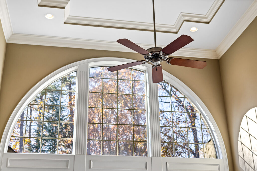 Brown ceiling fan on white ceiling