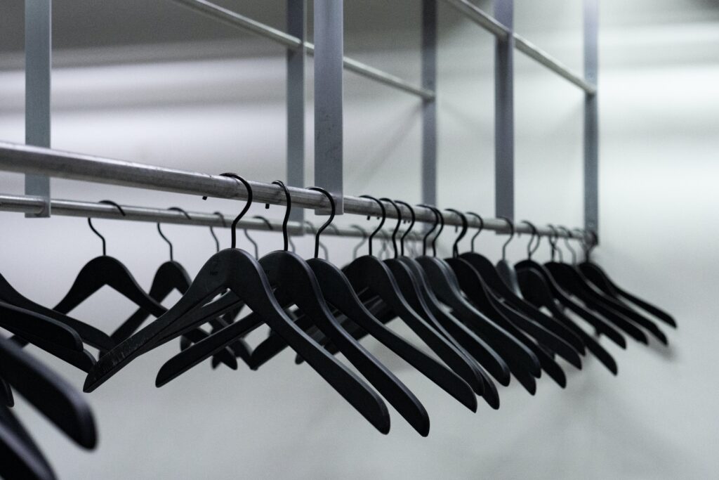 clothes hanged on gray metal wire