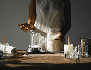 Crop black woman pouring wax into beaker