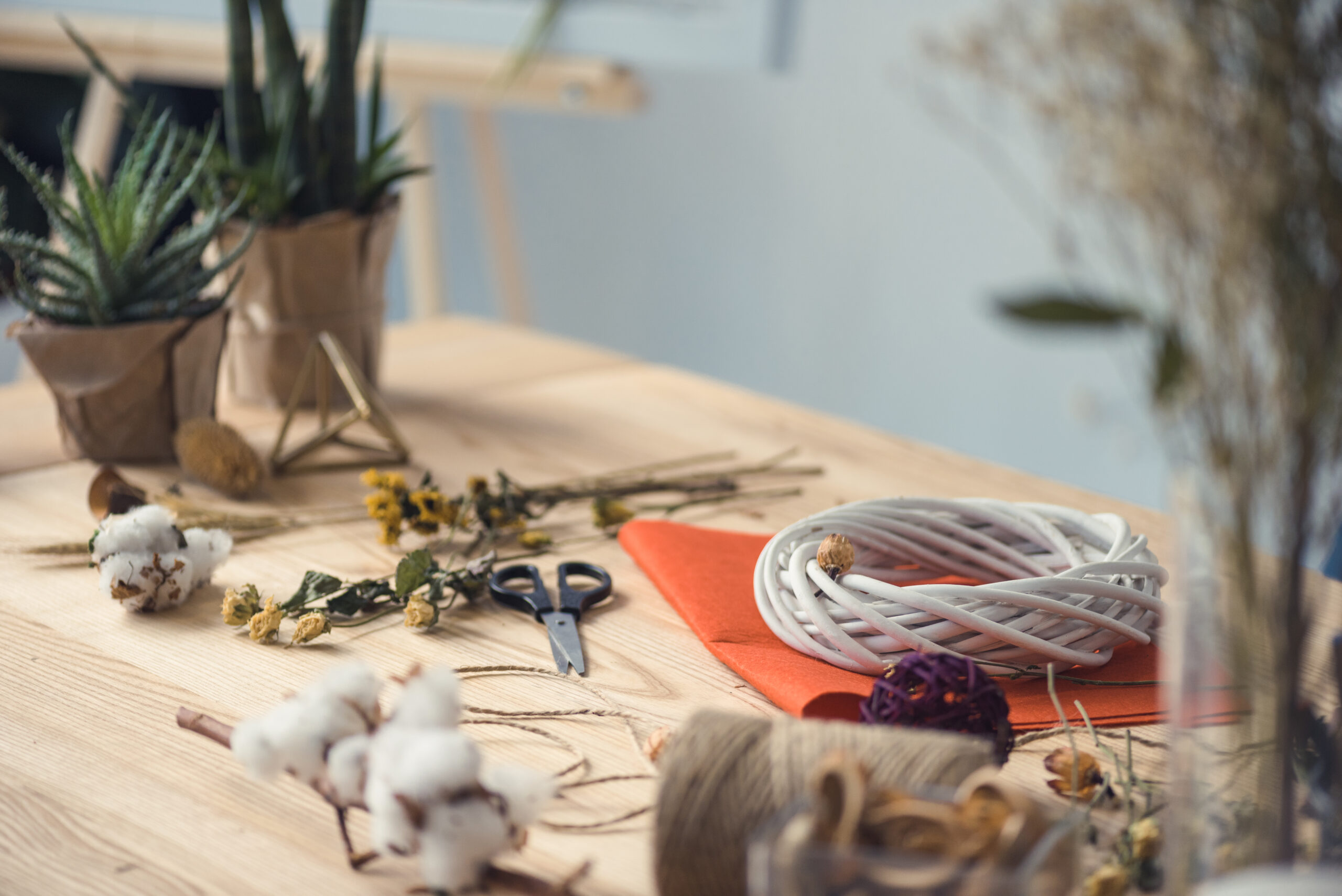 florist workplace with dry flowers, wreath and different supplies