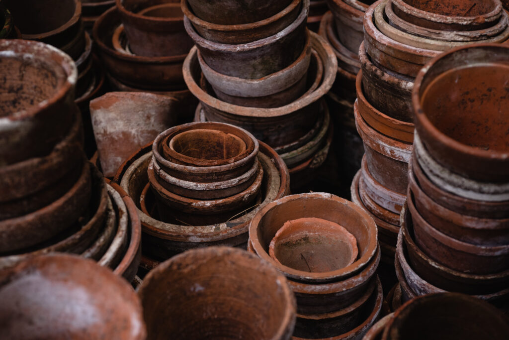 High angle photo of pile of brown round clay pots