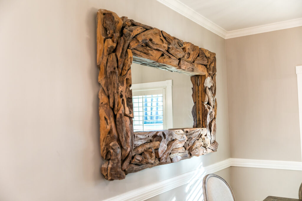 large driftwood mirror hanging on the wall