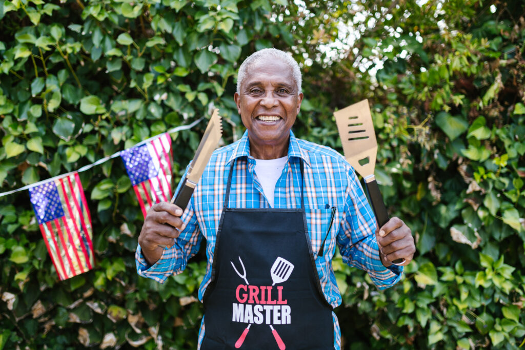 Man holding a spatula and a tongs