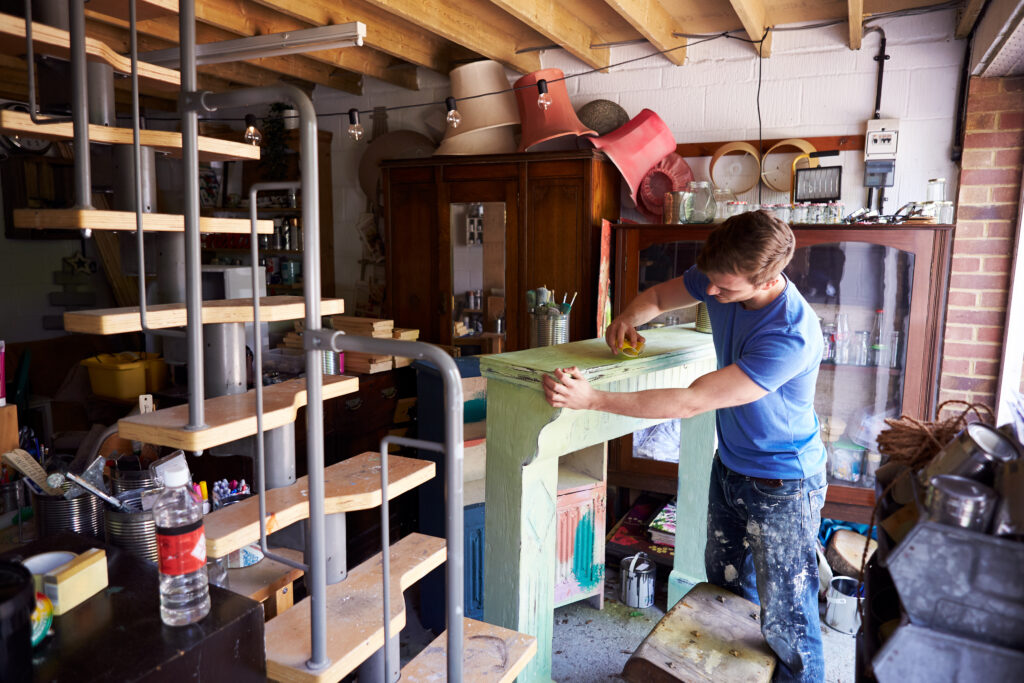 Man In Workshop Upcycling And Working On Fire Surround