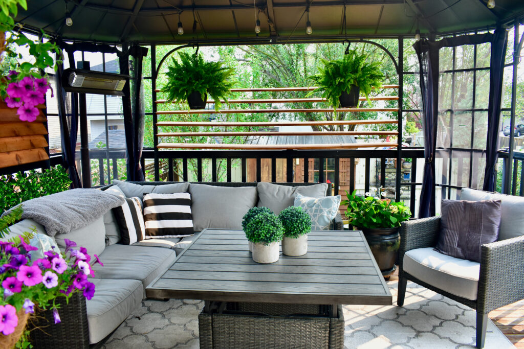 Sheltered outdoor summer lanai living space for relaxing on warm days in backyard oasis or tropical vacation rental setting