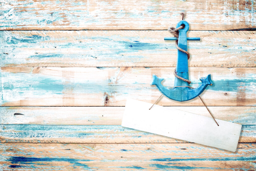 Vintage anchor on old wooden background with blue paint . vintage wood texture from beach in summer.