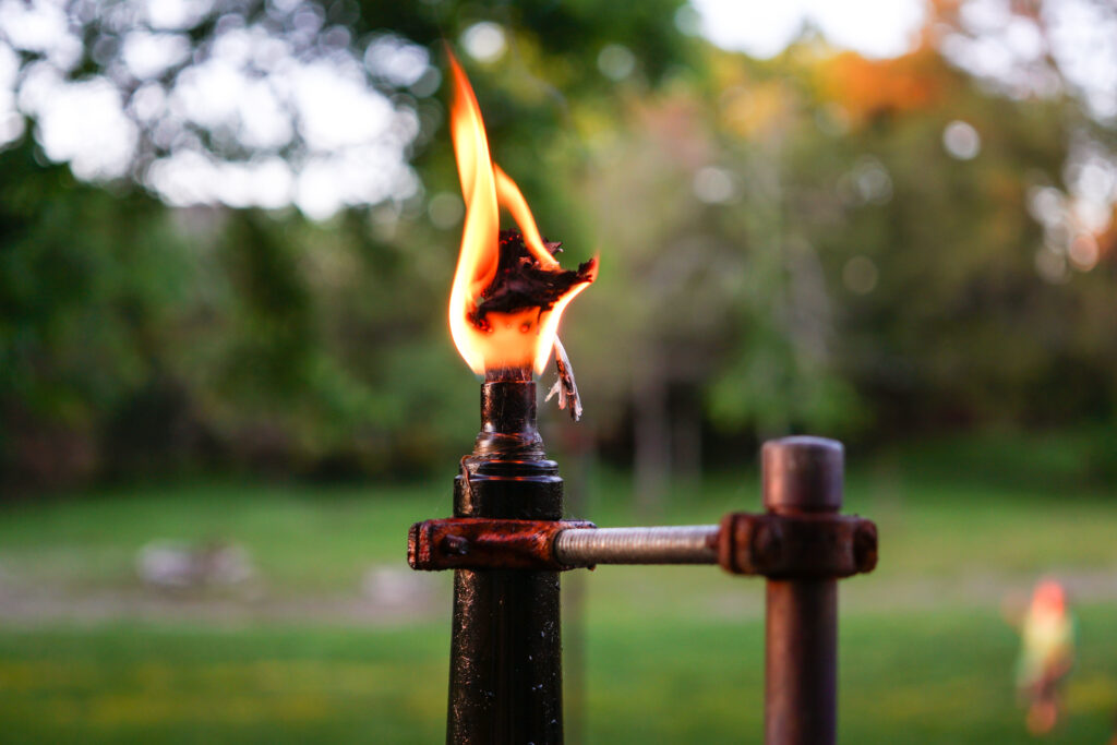 Wine bottle tiki torch with flame burning