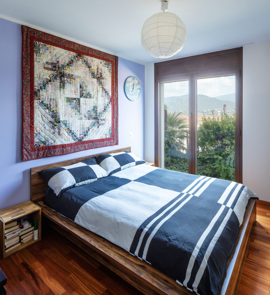 Bedroom with beautiful parquet, checked blankets