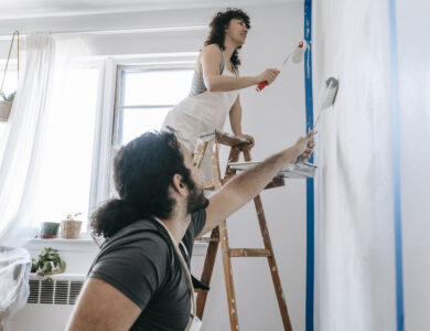 Couple painting a wall