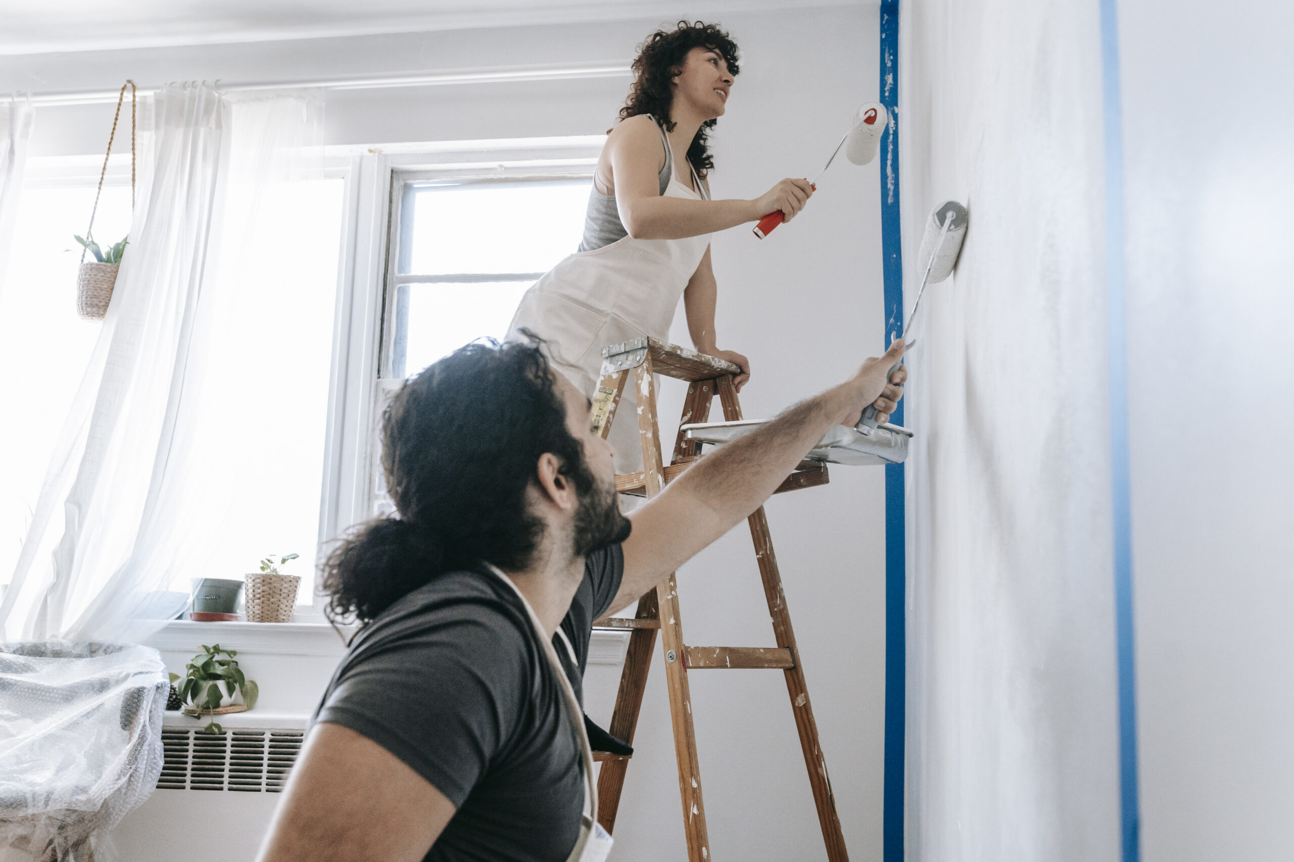 Couple painting a wall