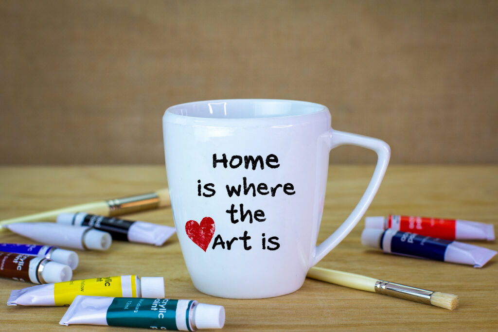 Home is where the art is hand painted on to a mug, creativity, using craft to make sustainable gifts and have fun.