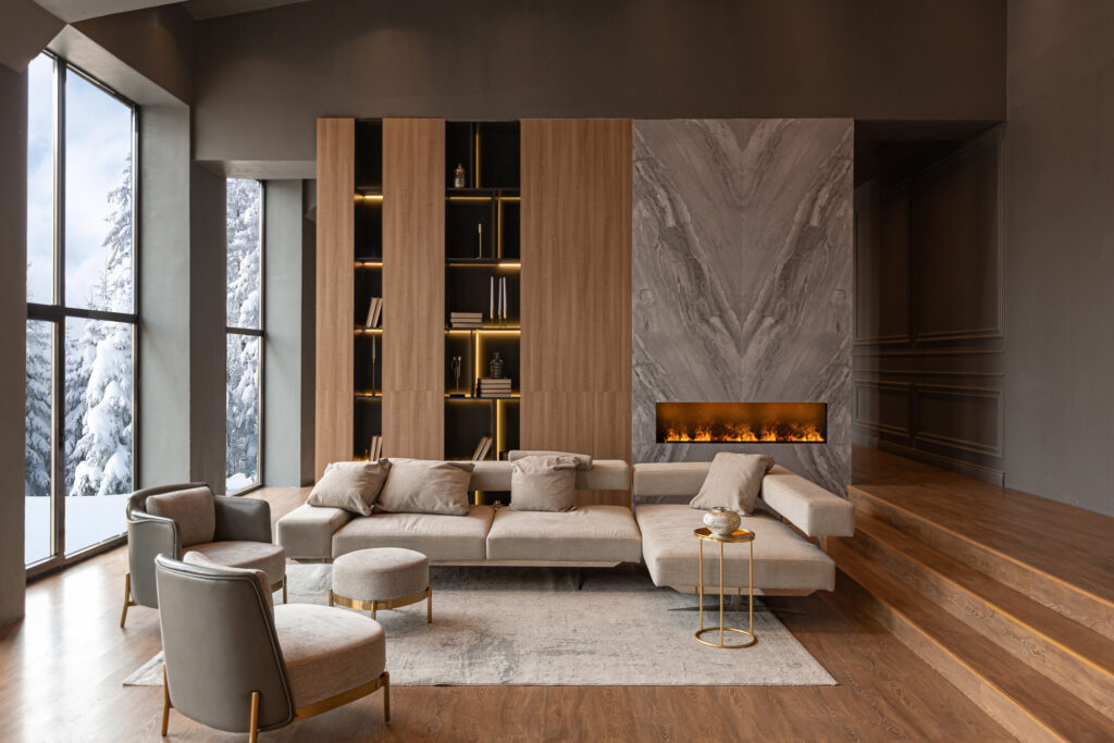 living room, marble wall fireplace and stylish bookcase in chic expensive interior of luxury country house with a modern design with wood and led light, gray furniture with gold elements