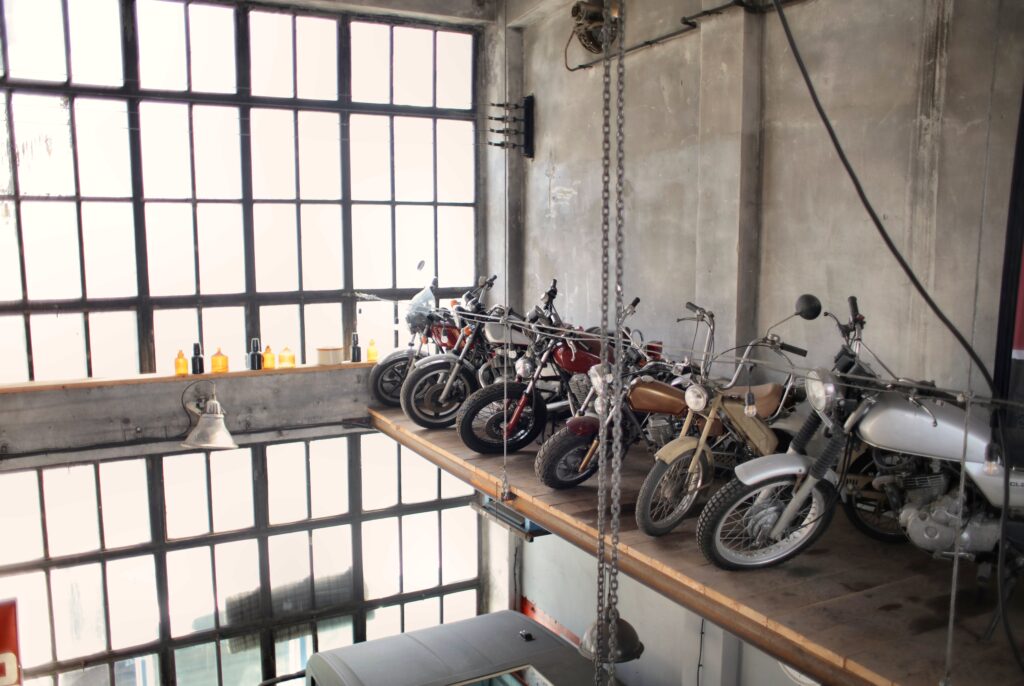 Retro motorbikes parked in row on special platform in garage