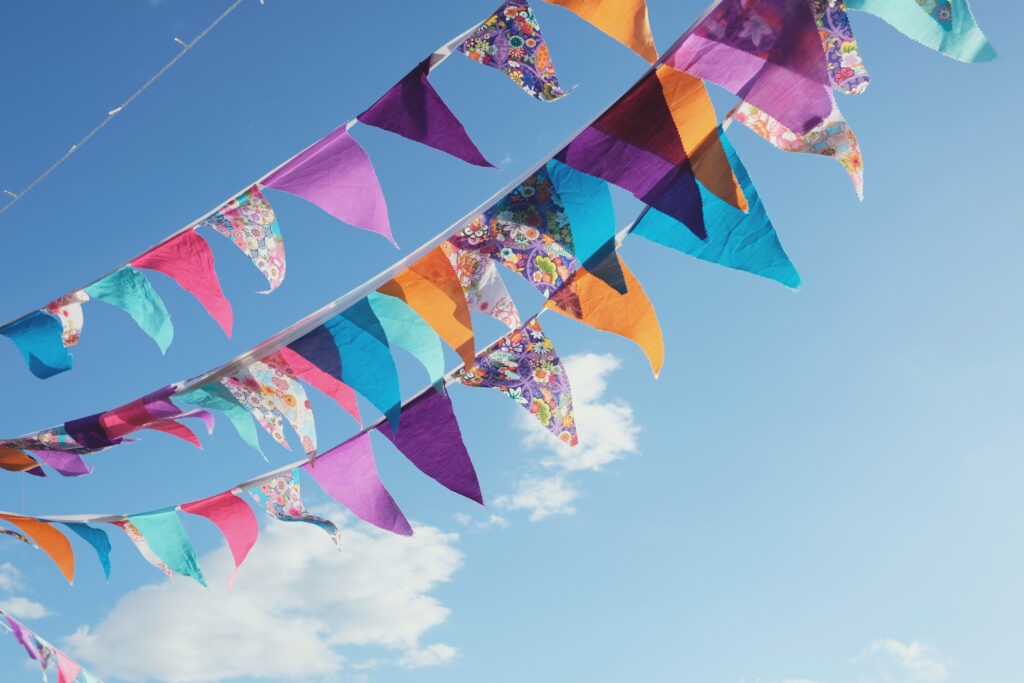 Summer festive colorful bunting and blue sky, summer event celebration