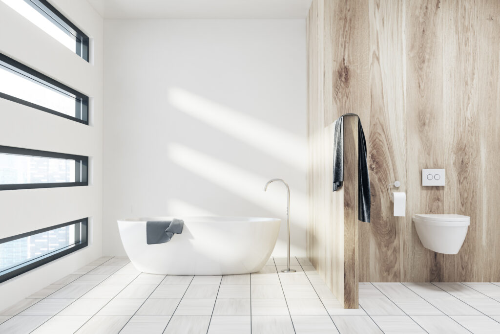 White bathroom with a tub, toilet