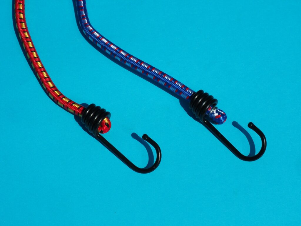 Bungee cord set with fixing hooks. Securing objects in car trunks. Elastic cords and tarp straps