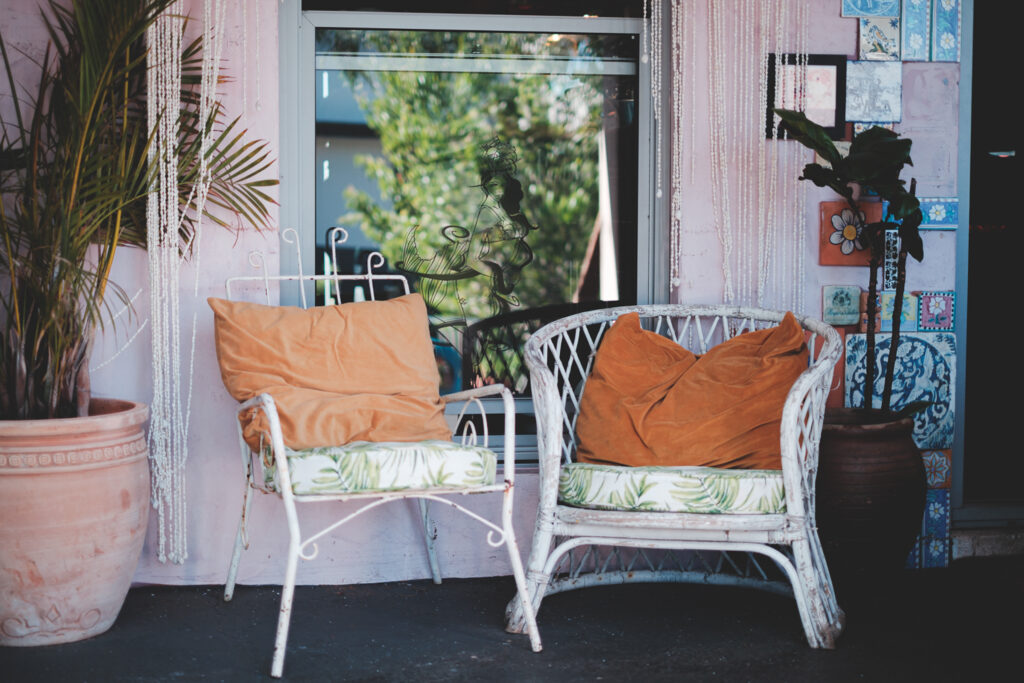Cozy wicker chairs on cottage terrace