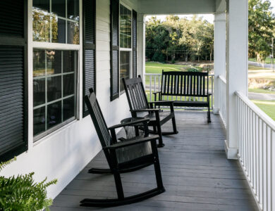 Front Porch of Southern home with Black Rocking Chairs and a Casual Feel