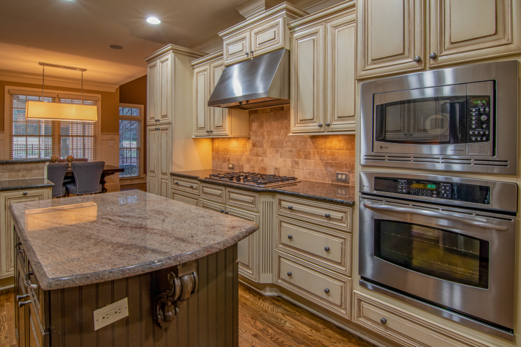 Silver microwave oven on brown wooden kitchen cabinet