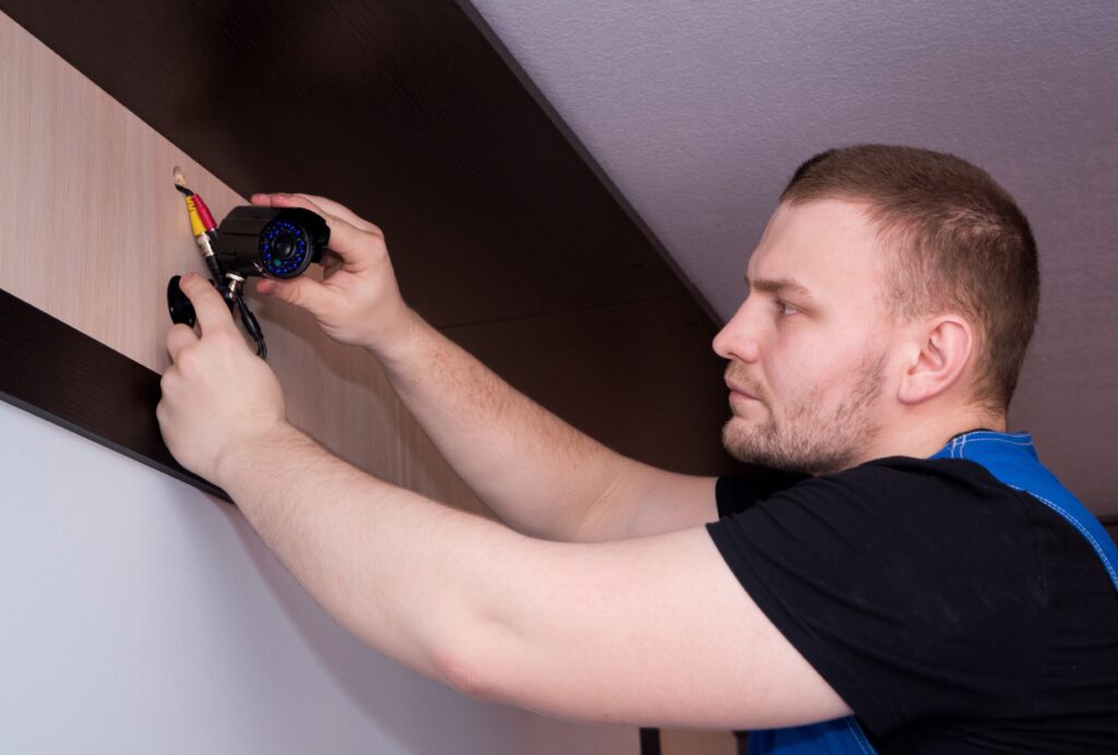 Technician fixing video surveillance camera