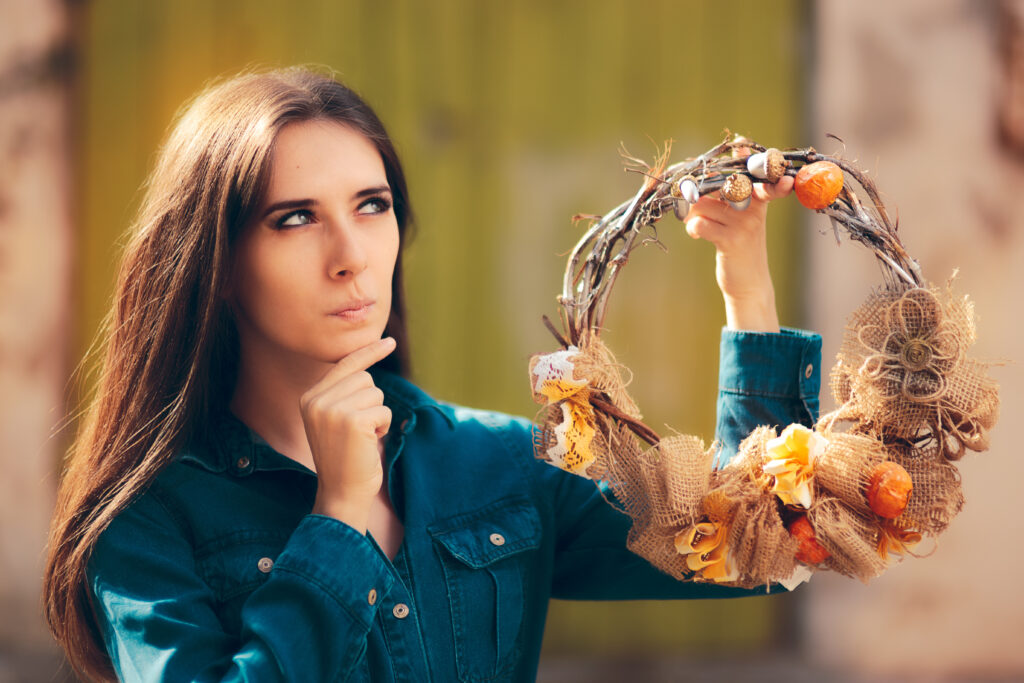 Thinking  Girl Holding Decorative Autumn Wreath