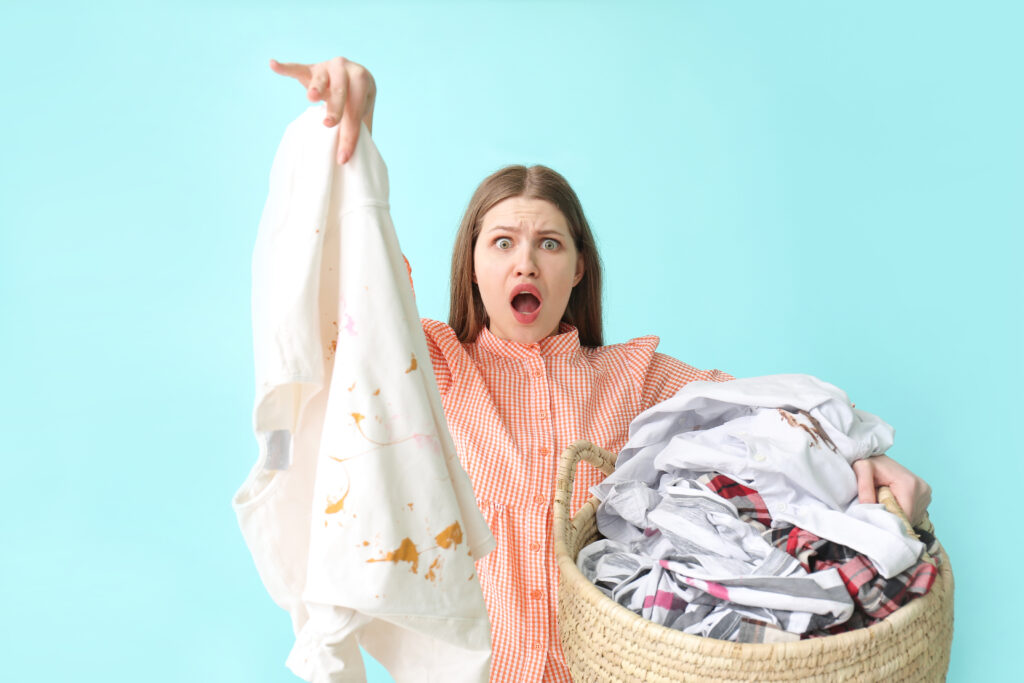 Troubled woman with dirty clothes on color background