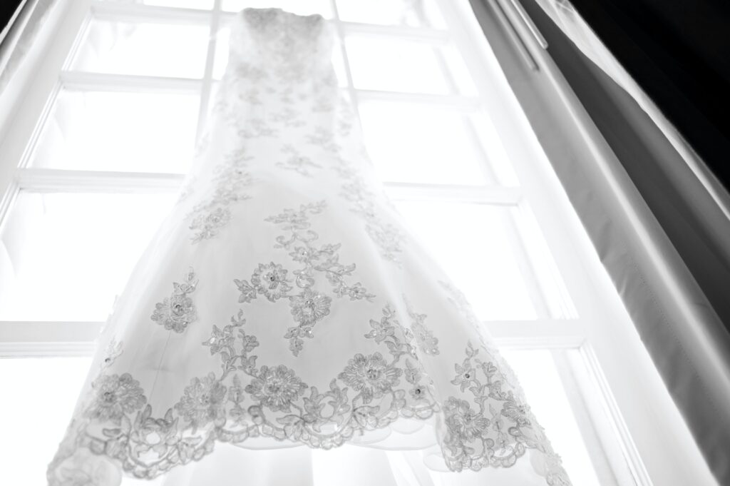 wedding dress hanging in window