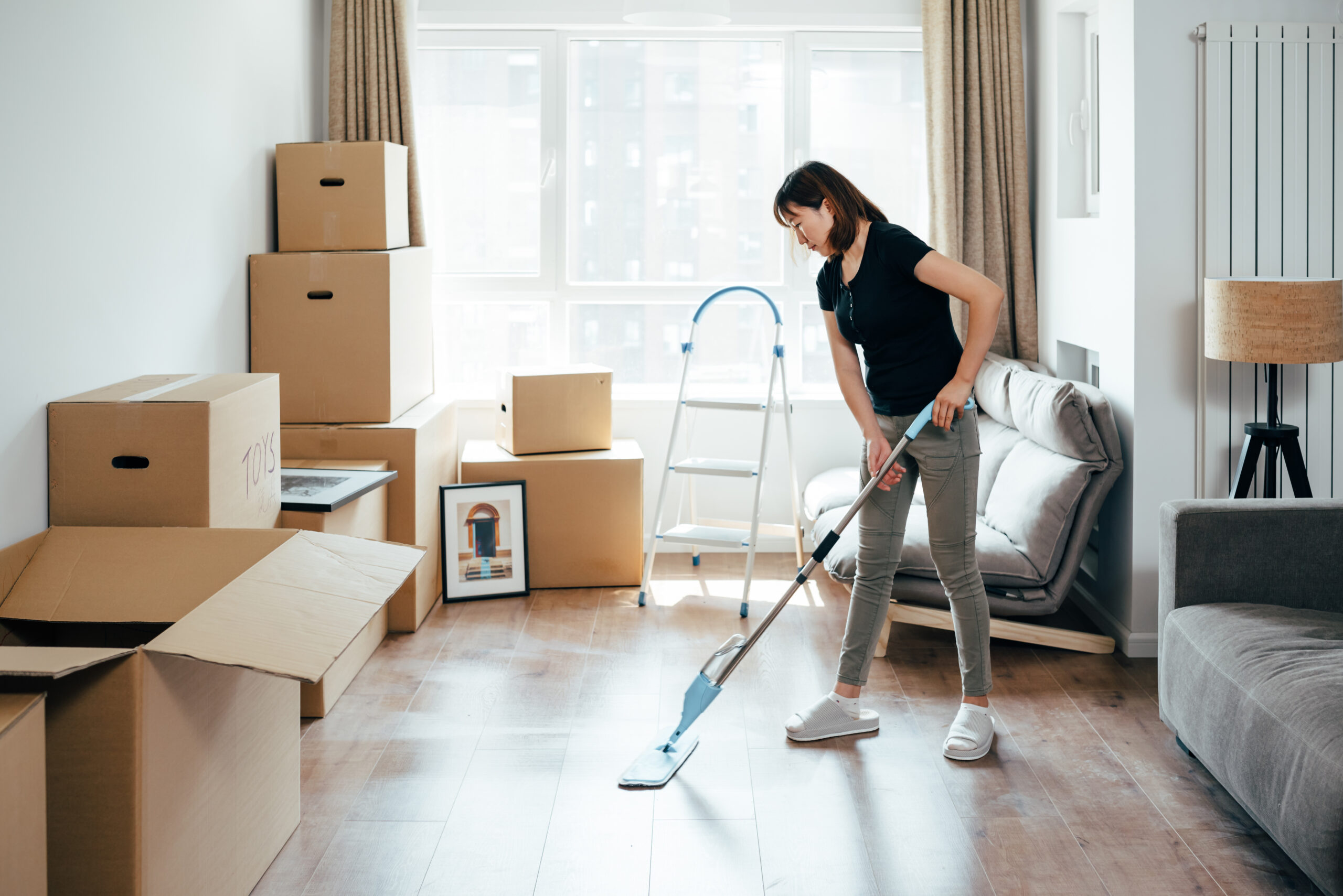 Young  woman cleaning at new home