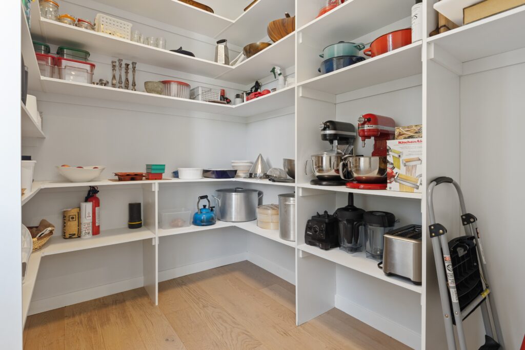 a white kitchen with white shelves