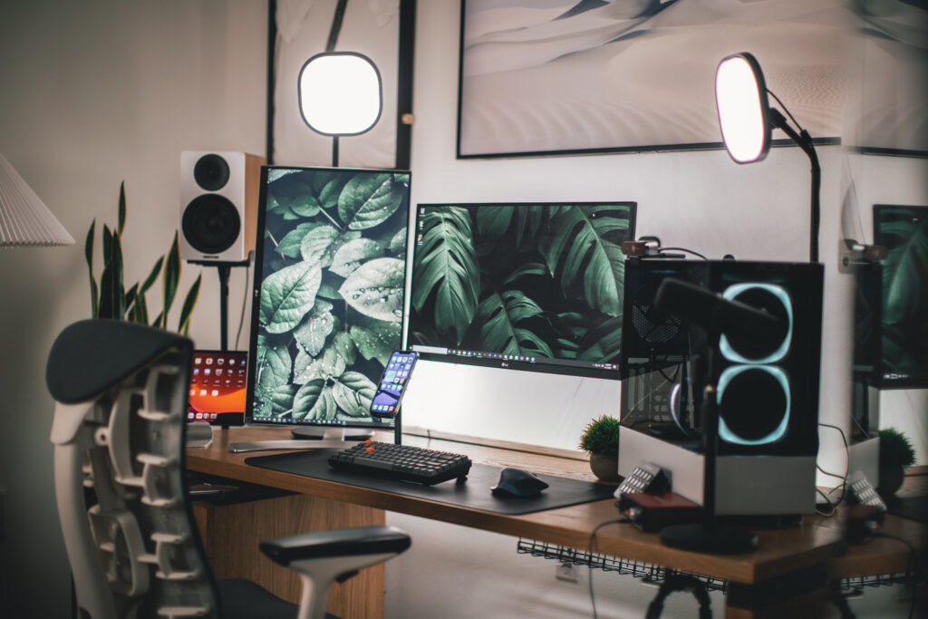 Black flat screen computer monitor on white wooden desk