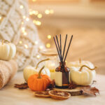 Cozy corner for home meditation and relaxation. Aroma diffuser, burning candles, pleasure and aromatherapy. Fall decor with pumpkins for apartment, house, indoors design. Thanksgiving decoration