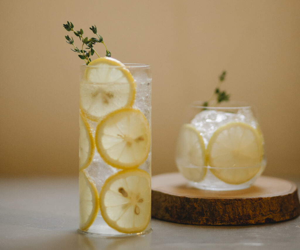 Glasses with lemon drink on table