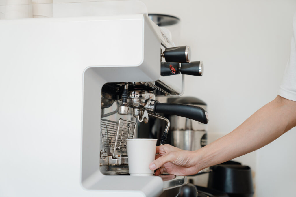 Person holding white cup