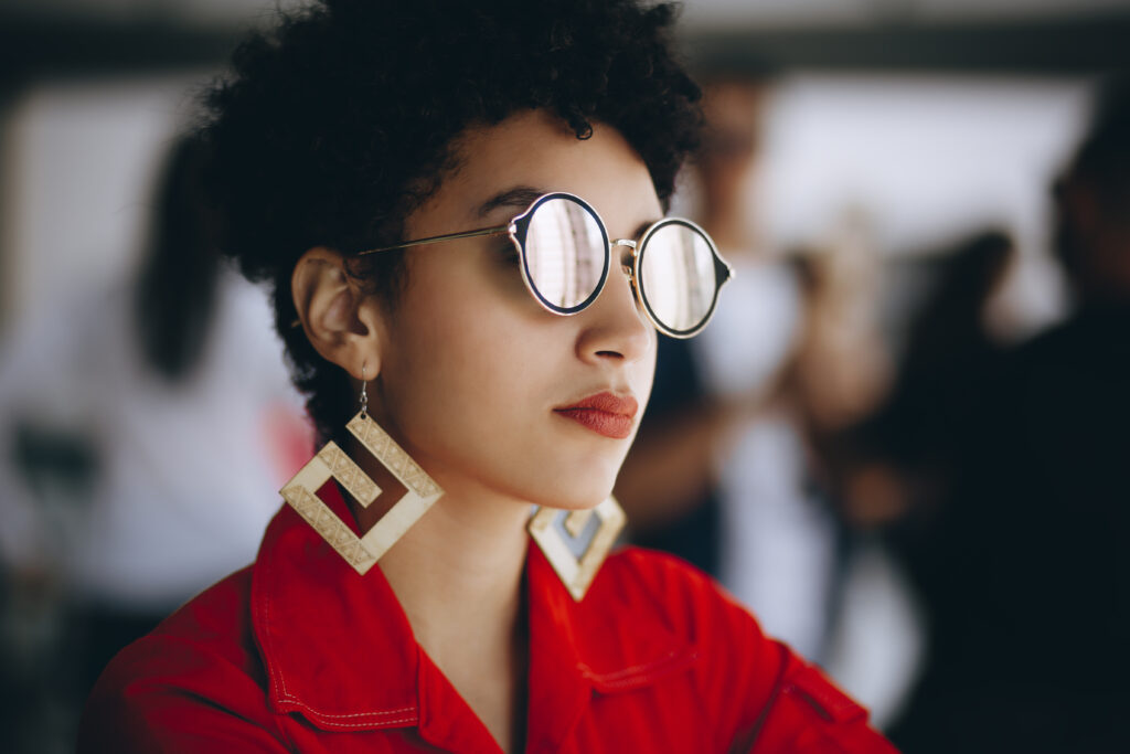 Woman in silver framed eyeglasses and red top