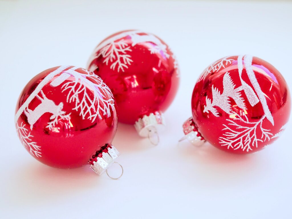Three white and red christmas tree printed baubles