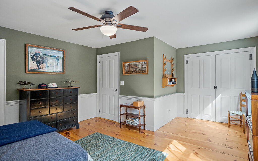 Vintage decoration of a comfortable bedroom with wooden furniture and a ceiling fan