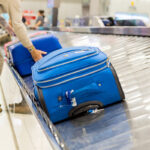 Grabbing luggage from baggage claim