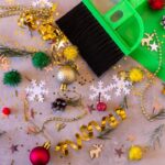 Christmas decorations and a green broom on a table