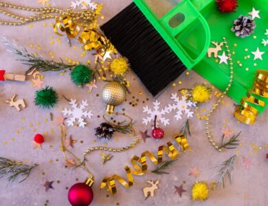 Christmas decorations and a green broom on a table