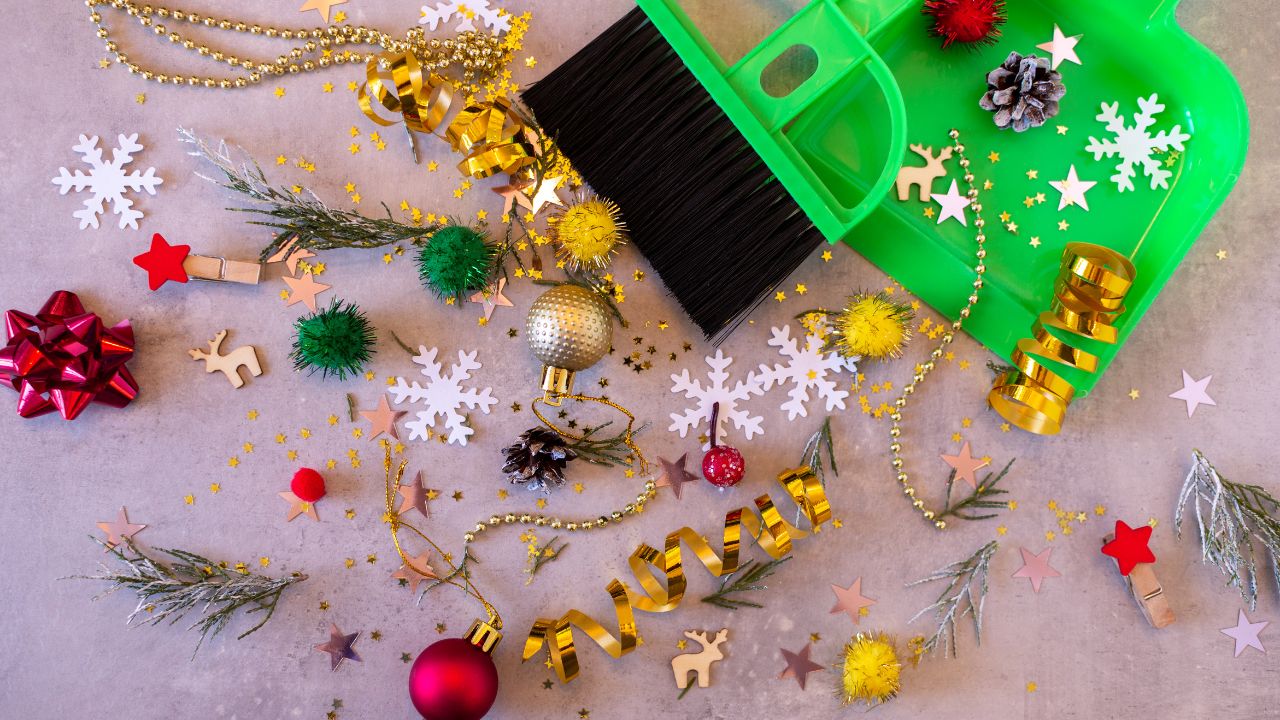 Christmas decorations and a green broom on a table