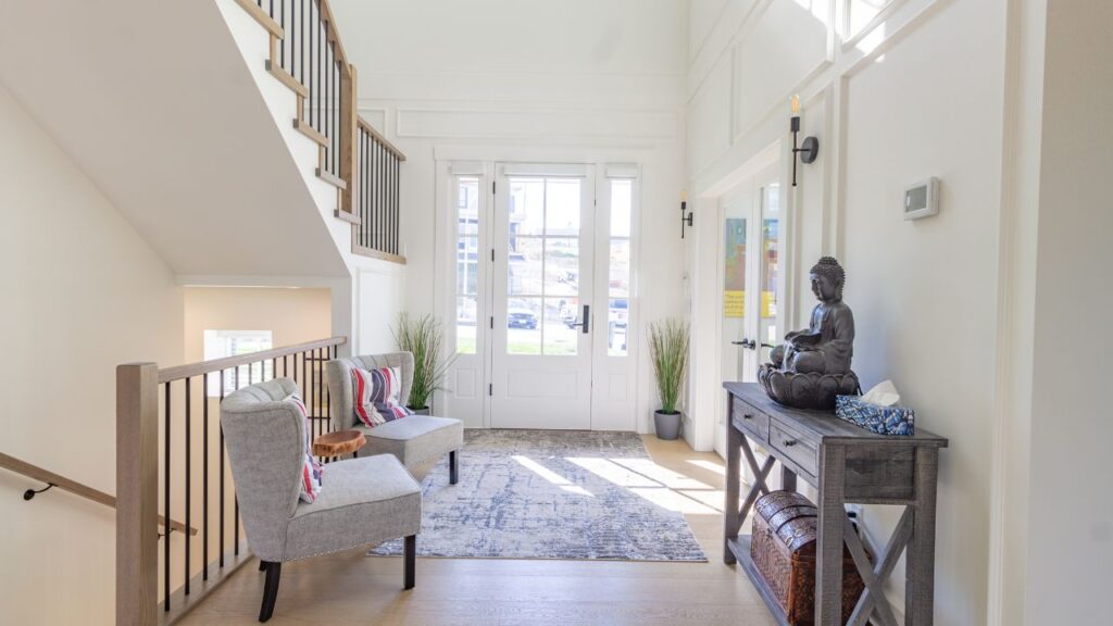 a foyer with stairs and white walls